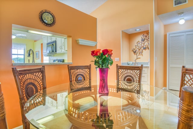 dining room featuring a textured ceiling and ceiling fan