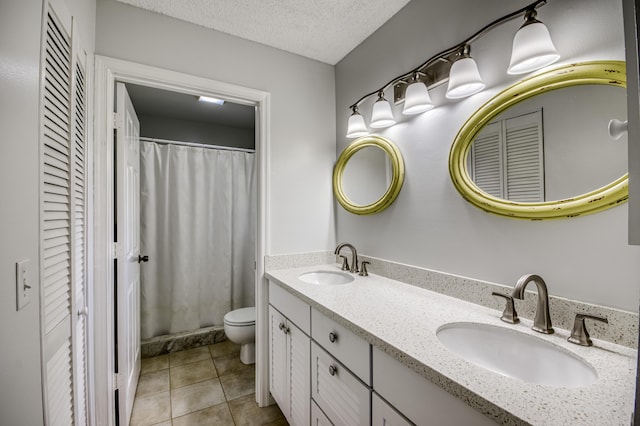 full bathroom featuring toilet, double vanity, tile patterned flooring, a textured ceiling, and a shower with curtain