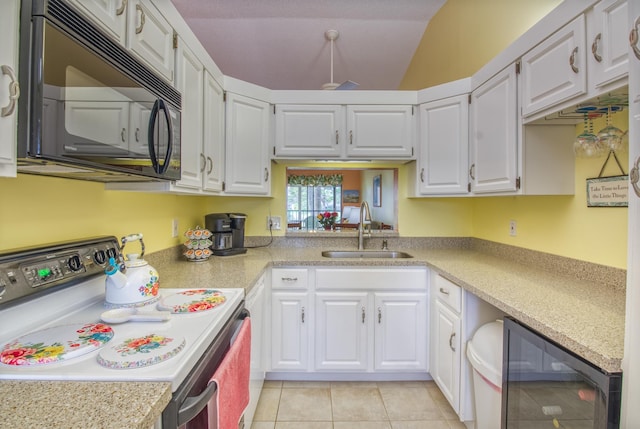 kitchen featuring wine cooler, range with electric stovetop, white cabinetry, and sink