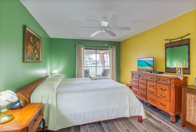 bedroom with ceiling fan, a textured ceiling, access to outside, and dark wood-type flooring