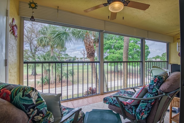 sunroom / solarium featuring ceiling fan