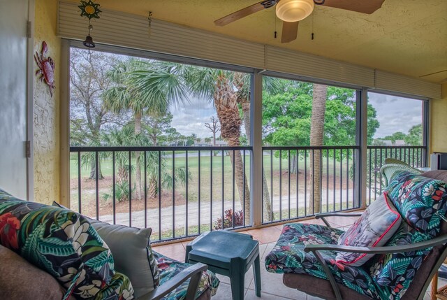 sunroom featuring ceiling fan