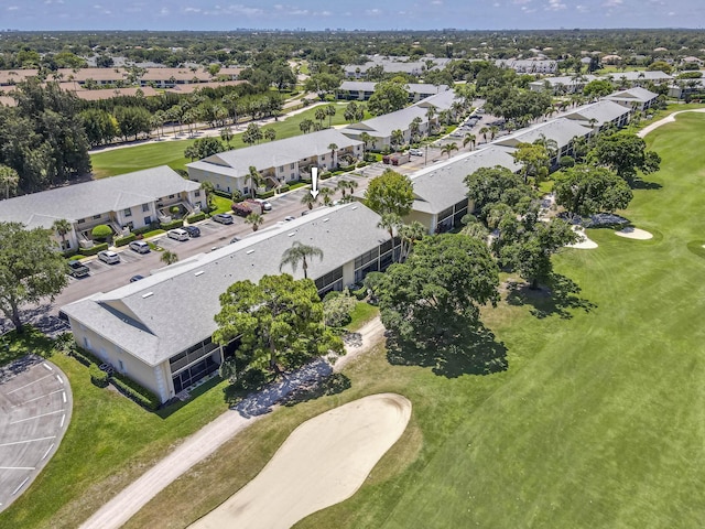 aerial view of property and surrounding area featuring a golf course