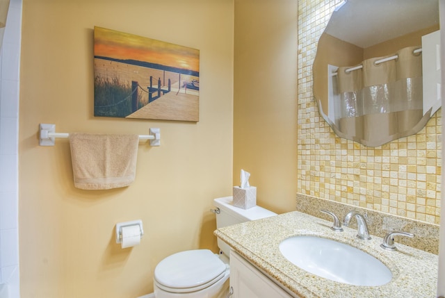 bathroom with vanity with extensive cabinet space and toilet