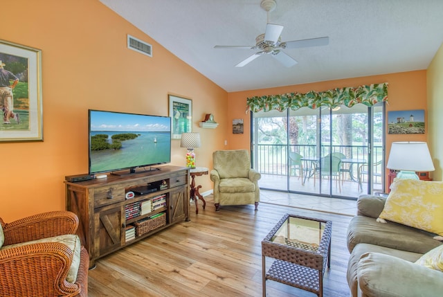 living room with vaulted ceiling, light hardwood / wood-style floors, and ceiling fan