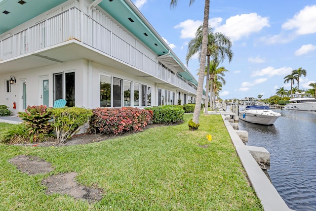 dock area featuring a yard and a water view