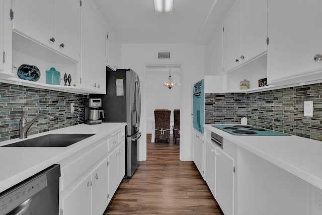 kitchen with appliances with stainless steel finishes, dark hardwood / wood-style flooring, and white cabinets