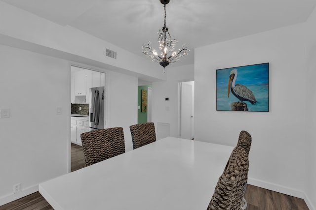 dining room with a chandelier and dark wood-type flooring