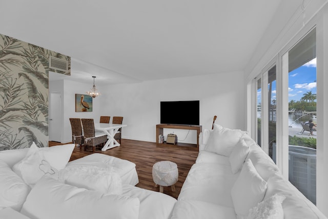 living room featuring an inviting chandelier and dark hardwood / wood-style floors