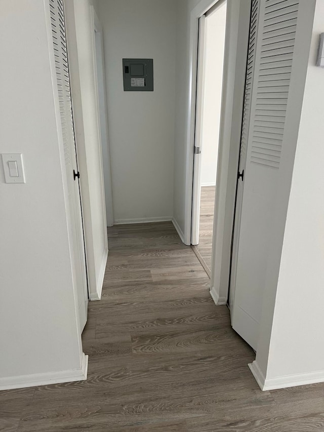 hallway with hardwood / wood-style floors