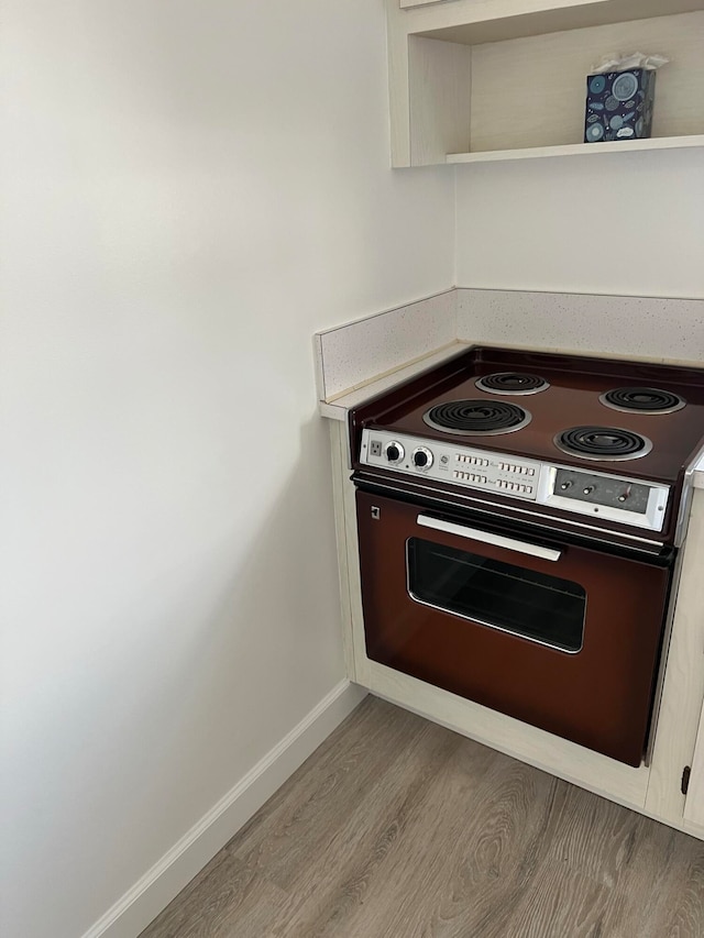 kitchen featuring white electric range and wood-type flooring