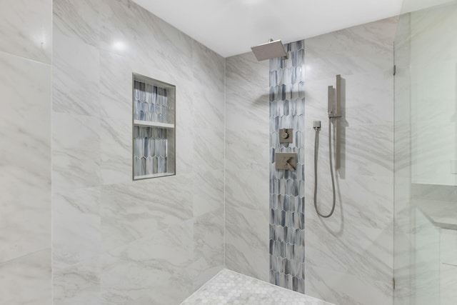 bathroom with tiled shower