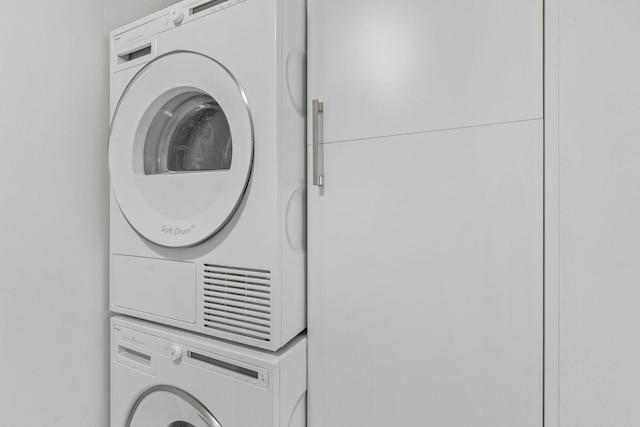 clothes washing area with stacked washer / drying machine