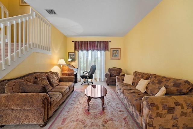 living room featuring light carpet and vaulted ceiling