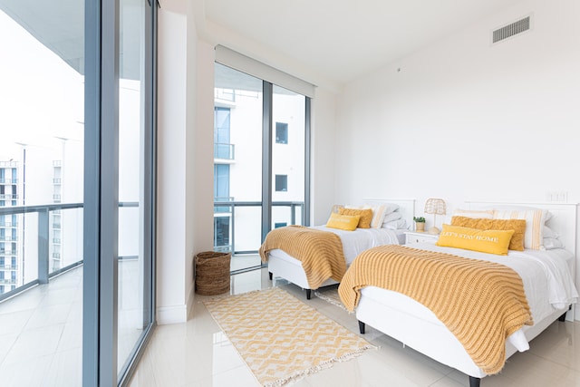 tiled bedroom featuring floor to ceiling windows