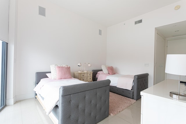 bedroom with light tile patterned floors