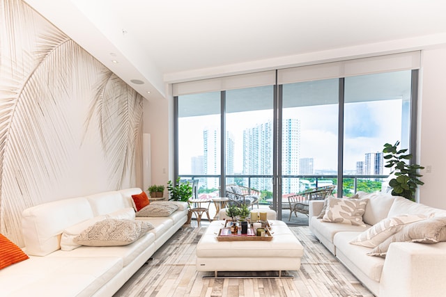 living room with light hardwood / wood-style flooring and a wall of windows