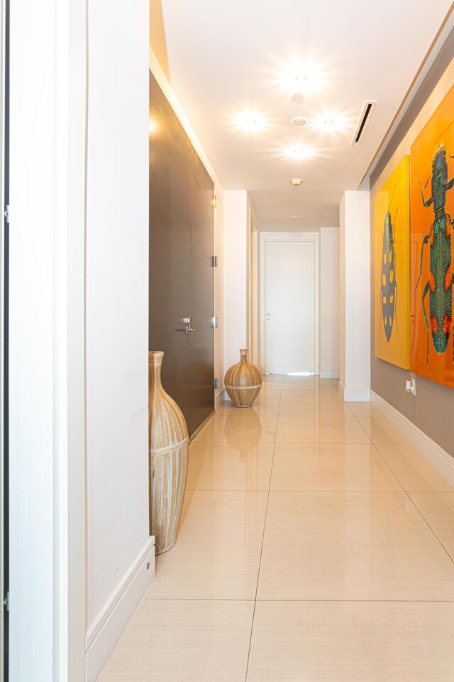 hallway with light tile patterned flooring