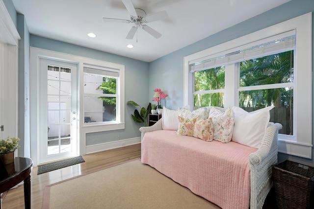 bedroom featuring a ceiling fan, recessed lighting, baseboards, and wood finished floors