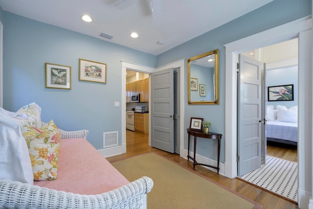 bedroom featuring recessed lighting, wood finished floors, visible vents, and baseboards