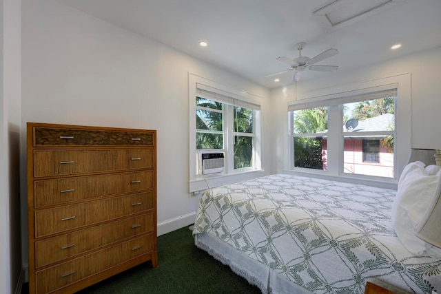 bedroom with ceiling fan, dark carpet, and cooling unit