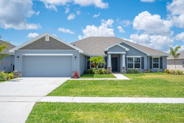 craftsman inspired home featuring a front yard and a garage