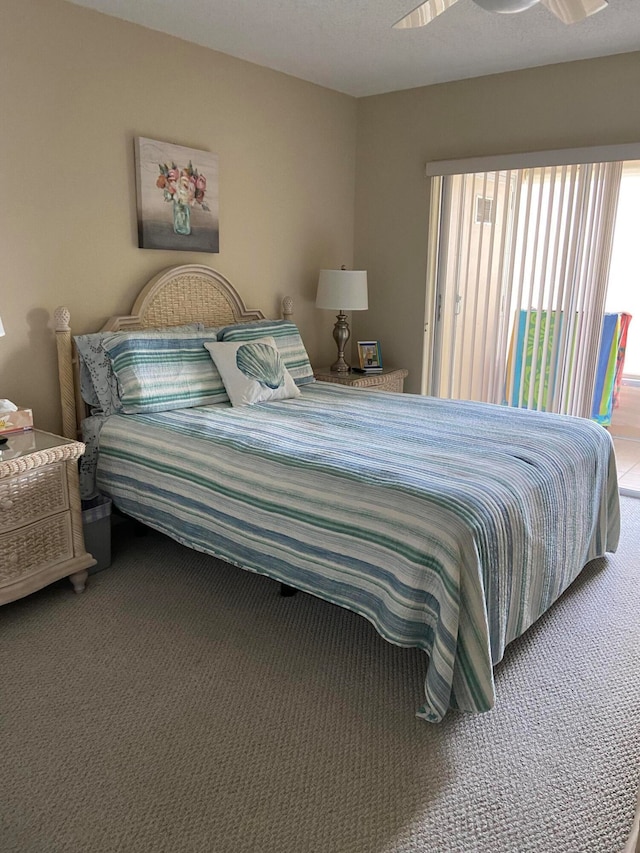 bedroom featuring dark carpet and ceiling fan