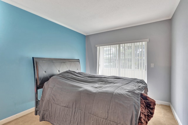 bedroom with a textured ceiling, crown molding, and light tile flooring