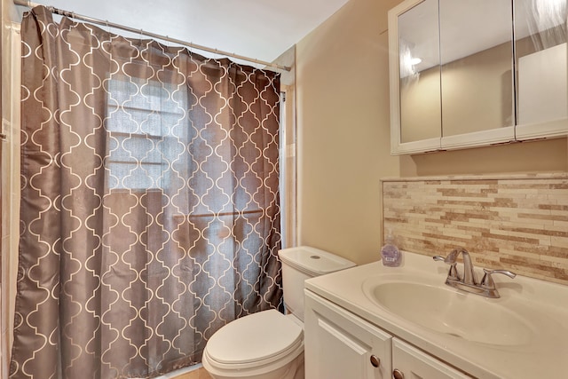 bathroom with toilet, tasteful backsplash, and vanity