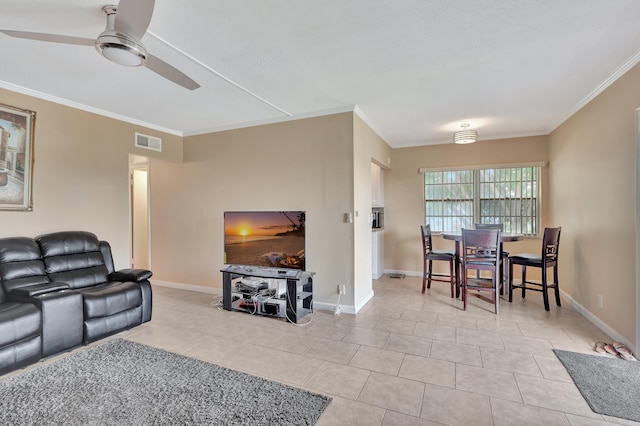 living room featuring crown molding, light tile flooring, and ceiling fan