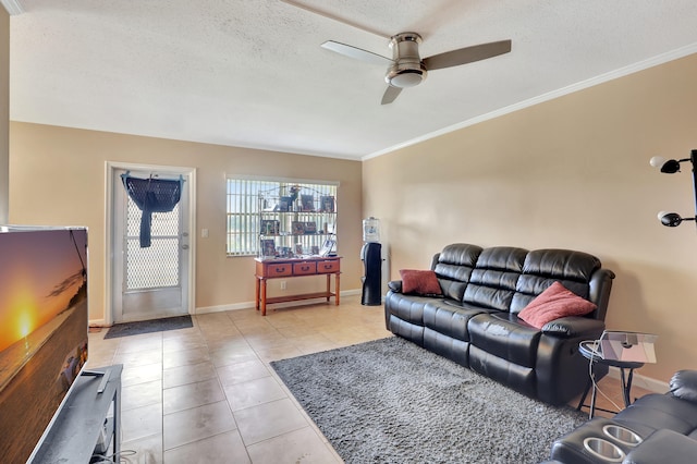 tiled living room featuring a textured ceiling, ceiling fan, and ornamental molding