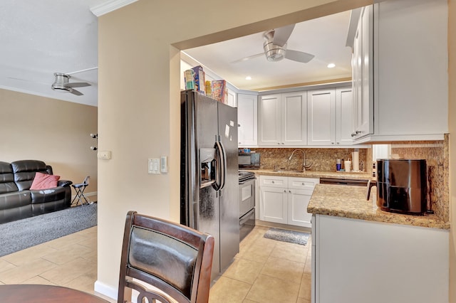 kitchen with ceiling fan, tasteful backsplash, stainless steel appliances, and light tile floors