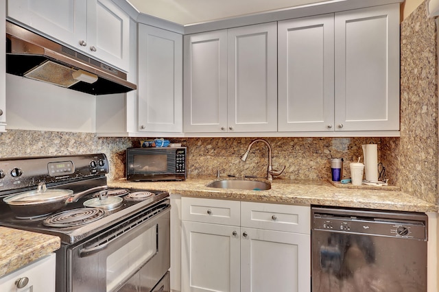 kitchen with backsplash, light stone counters, black appliances, and sink