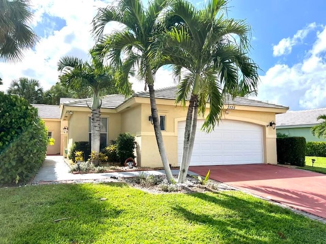 view of front of property featuring a front yard and a garage