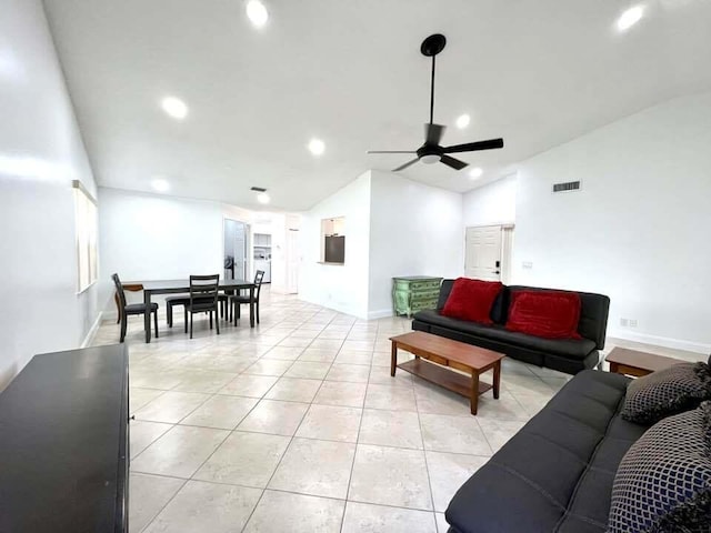 living room featuring lofted ceiling, ceiling fan, and light tile flooring