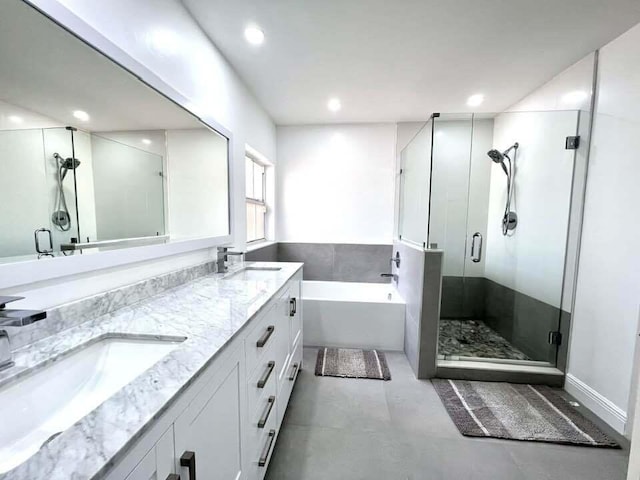 bathroom with double sink, tile flooring, independent shower and bath, and oversized vanity