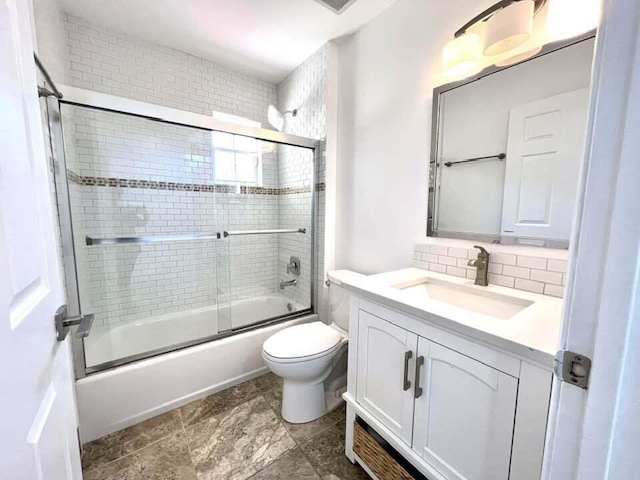 full bathroom with vanity, backsplash, tile floors, toilet, and enclosed tub / shower combo