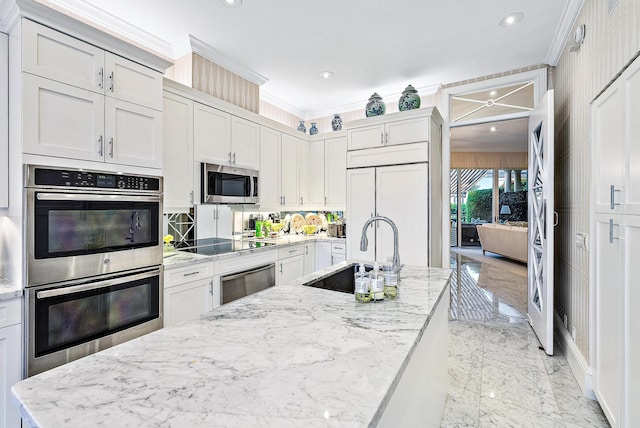 kitchen with light stone countertops, backsplash, sink, stainless steel appliances, and ornamental molding