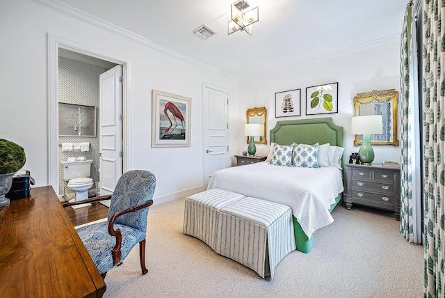 bedroom featuring ornamental molding, ensuite bath, and light colored carpet