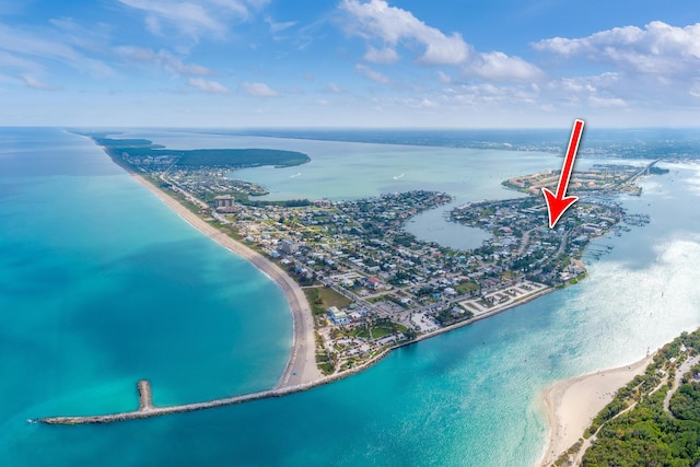 aerial view with a water view and a beach view