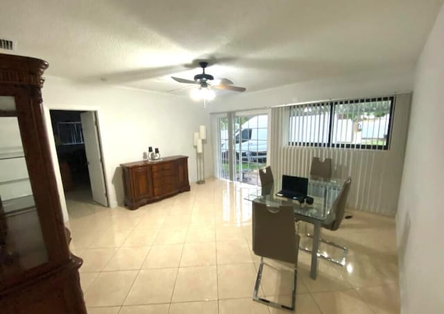 office with light tile floors and ceiling fan