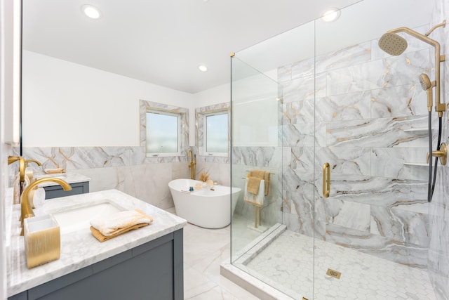 bathroom featuring tile walls, vanity, and plus walk in shower