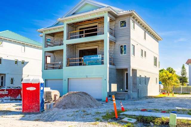 view of front of house with a balcony and a garage