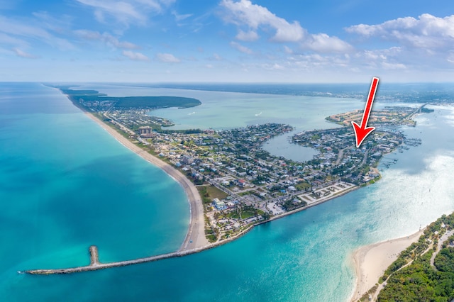 drone / aerial view featuring a water view and a beach view