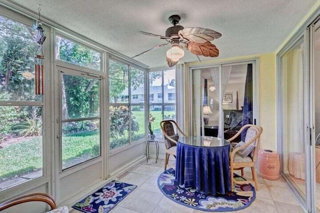 sunroom / solarium featuring ceiling fan