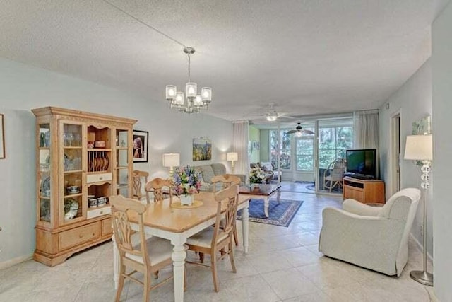 dining area featuring ceiling fan with notable chandelier and a textured ceiling