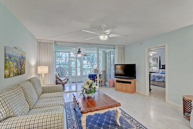 tiled living room with ceiling fan and a textured ceiling