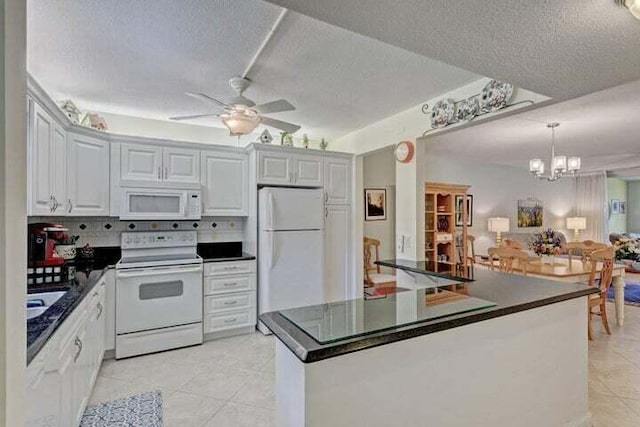 kitchen featuring ceiling fan with notable chandelier, white appliances, a textured ceiling, and white cabinetry