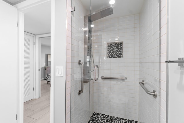 bathroom featuring walk in shower and tile floors