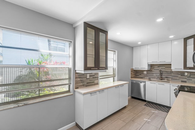 kitchen with white cabinetry, tasteful backsplash, and dishwasher